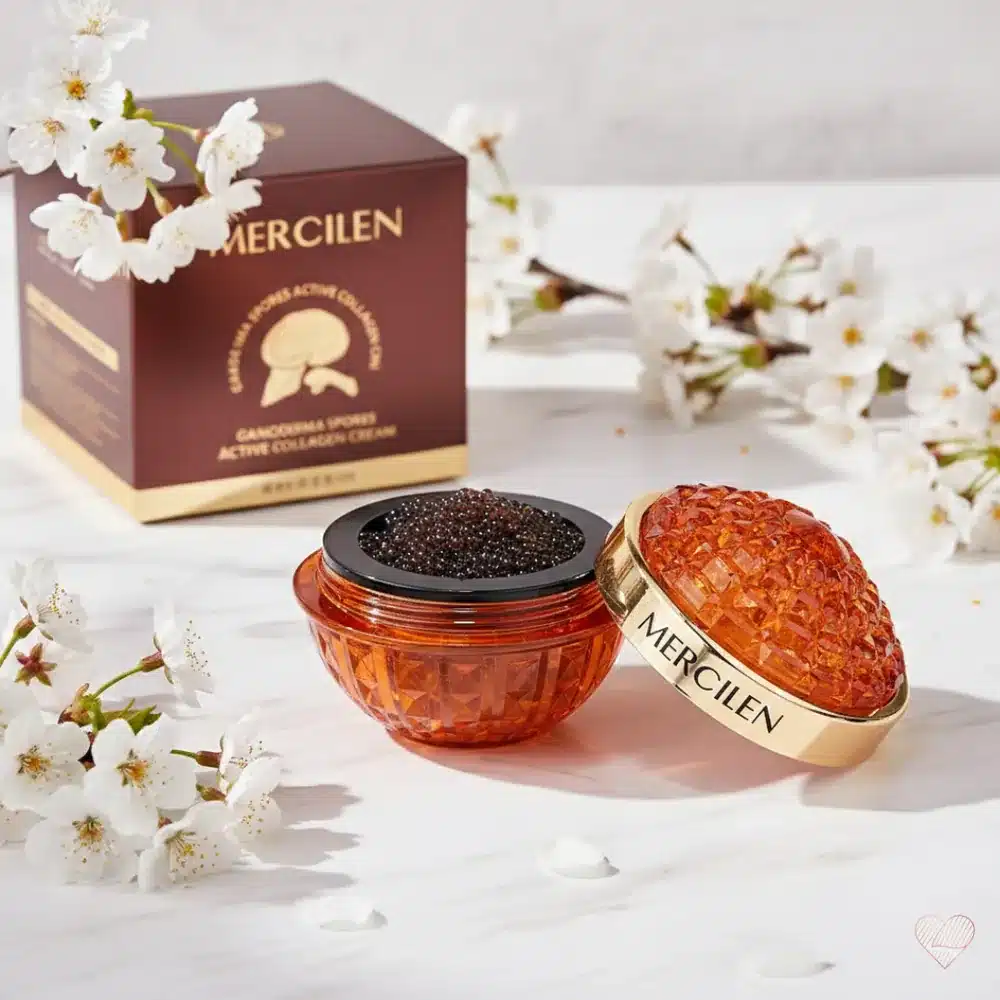 Oranssi, jalokiveä muistuttava Mercilen Ganoderma & Collagen -kasvovoidepurkki ja viininpunainen pakkaus.