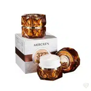 Meripihkan värinen, jalokivimäinen Mercilen-kasvovoidetölkki ja sen valkoinen, kohokuvioitu tuotepakkaus.