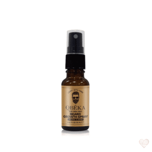 Ruskea lasinen suihkepullo, jonka kultaisessa etiketissä lukee QBÉKA Beard Growth Spray ja on parrakkaan miehen kasvokuva.